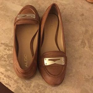 Brown loafers with gold detail